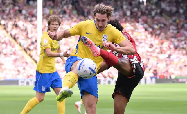 Sheffield United's Sam McCallum, right, and Birmingham City's Phil Neumann in action during the Championship soccer match between Sheffield United and Birmingham City in Sheffield, England, Saturday Aug. 15, 2026. (Gary Oakley/PA via AP)