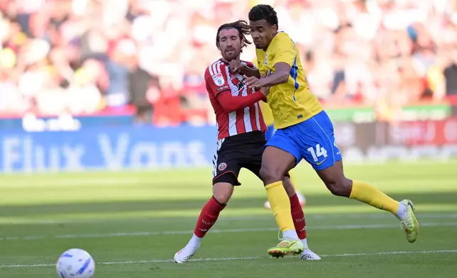 Sheffield United's Joe Rothwell, left, and Birmingham City's Jhon Solis in action the Championship soccer match between Sheffield United and Birmingham City in Sheffield, England, Saturday Aug. 15, 2026. (Gary Oakley/PA via AP)