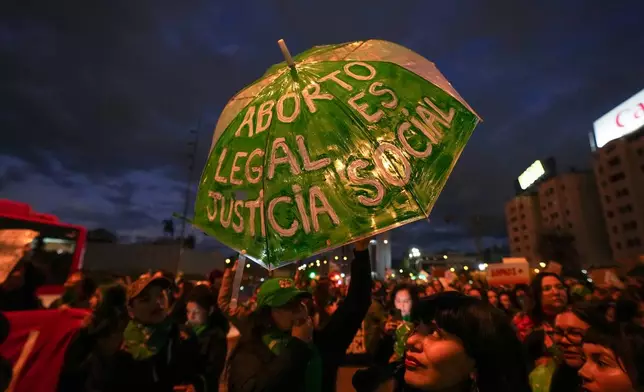 Demonstrators protest a proposed bill that would require women to listen to a fetal heartbeat before undergoing an abortion, in Santiago, Chile, Friday, July 31, 2026. (AP Photo/Esteban Felix)