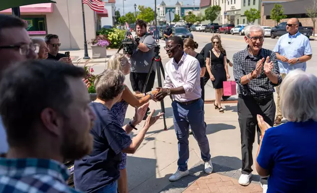 David Crowley, Democratic candidate for Wisconsin governor, shakes hands with supporters while campaigning with Wisconsin Gov. Tony Evers, right, Friday, Aug. 7, 2026, in Sheboygan, Wis. (AP Photo/Kayla Wolf)