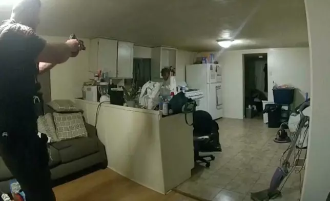 FILE - In this image from body camera video released by Illinois State Police, Sangamon County Sheriff's Deputy Sean Grayson, left, points his gun at Sonya Massey, who called 911 for help, before shooting and killing her inside her home in Springfield, Ill., July 6, 2024. (Illinois State Police via AP, File)