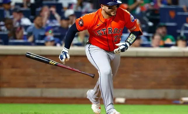 Houston Astros' Yainer Diaz tosses his bat after hitting an RBI single against the New York Mets during the sixth inning of a baseball game, Friday, Aug. 28, 2026, in New York. (AP Photo/Noah K. Murray)