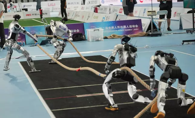 Humanoid robots compete in the tug of war during the World Humanoid Robot Games in Beijing, Tuesday, Aug. 25, 2026. (AP Photo/Achmad Ibrahim)