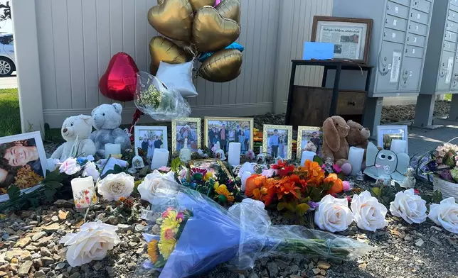 Flowers sit at a memorial honoring eight family members who were killed while gathering for dinner near the family home outside Billings, Mont., Wednesday, Aug. 26, 2026. (AP Photo/Matthew Brown)