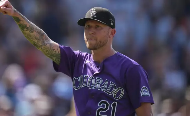 Colorado Rockies starting pitcher Kyle Freeland gestures to the crowd after throwing a complete basebaall game against the Kansas City Royals, Sunday, Aug. 2, 2026, in Denver. (AP Photo/David Zalubowski)