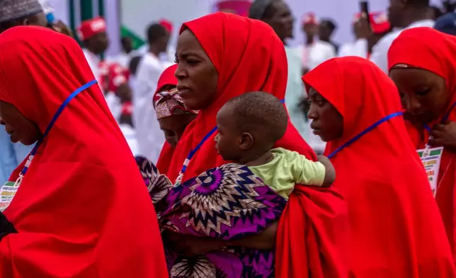Nigerian brides attend a mass wedding ceremony in Kano, Nigeria, Saturday, Aug 8, 2026. (AP Photo/Sani Maikatanga)