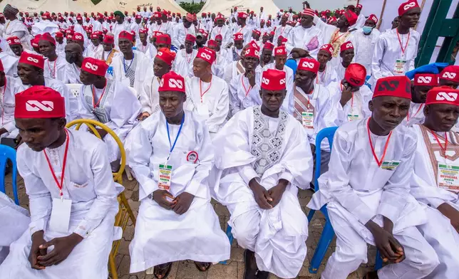 Nigerian grooms attend a mass wedding ceremony in Kano, Nigeria, Saturday, Aug. 8, 2026. (AP Photo/Sani Maikatanga)