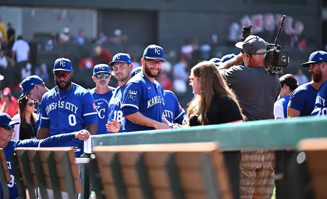 Kansas City Royals pitcher Noah Cameron, center, is greeted by teammates after pitching a complete baseball game to defeat the Los Angeles Angels, Sunday, Aug. 16, 2026, in Anaheim, Calif. (AP Photo/William Liang)