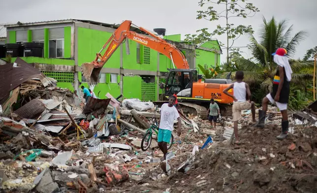 A backhoe clears earthquake debris in Quibdo, Colombia, Monday, Aug. 17, 2026. (AP Photo/Paula Orozco)