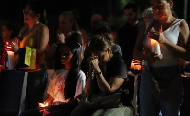 People gather at a vigil for earthquake victims in Cali, Colombia, Saturday, Aug. 15, 2026. (AP Photo/Santiago Saldarriaga)