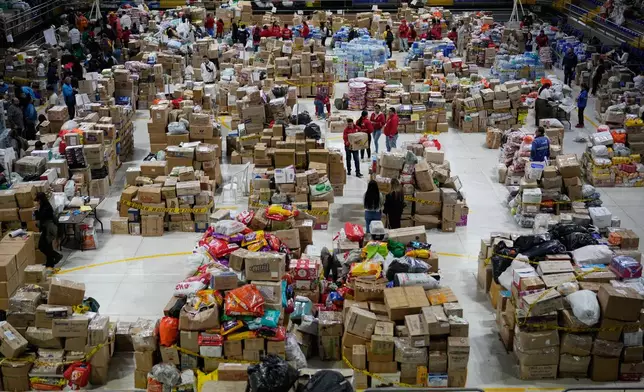 Volunteers sort aid bound for people affected by the earthquake in Choco department, in Bogota, Colombia, Tuesday, Aug. 18, 2026. (AP Photo/Fernando Vergara)
