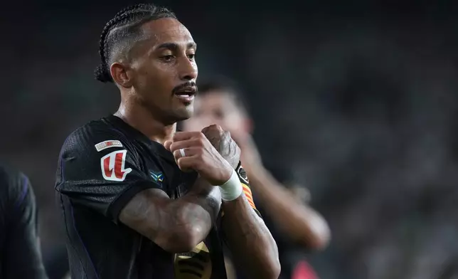 Barcelona's Raphinha celebrates after scoring his side's third goal during a Spanish La Liga soccer match between Elche and Barcelona in Elche, Spain, Sunday, Aug. 23, 2026. (AP Photo/Alberto Saiz)