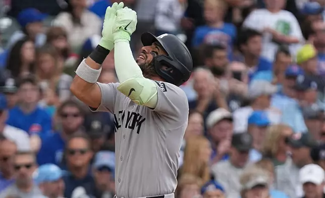New York Yankees' José Caballero gestures after hitting a two-run home run against the Chicago Cubs during the third inning of a baseball game Sunday, Aug. 2, 2026, in Chicago. (AP Photo/David Banks)
