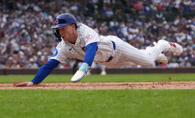 Chicago Cubs' Pete Crow-Armstrong dives back into first base safely against the New York Yankees during the eighth inning of a baseball game Sunday, Aug. 2, 2026, in Chicago. (AP Photo/David Banks)