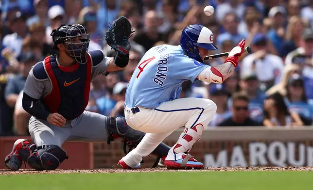 Chicago Cubs' Pete Crow-Armstrong (4) ducks below a pitch as St. Louis Cardinals catcher Iván Herrera, left, waits to catch the ball during the sixth inning of a baseball game in Chicago, Friday, Aug. 14, 2026. (AP Photo/Jessie Alcheh)