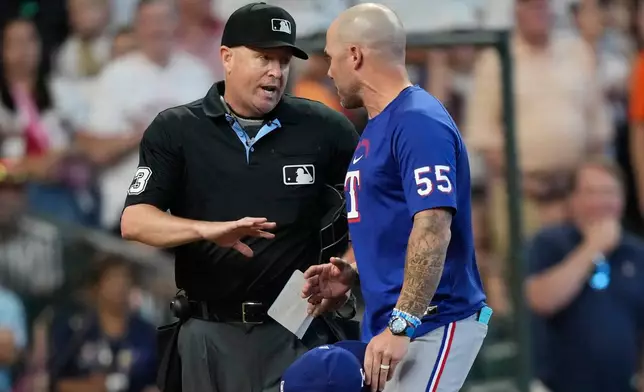 Texas Rangers manager Skip Schumaker (55) argues with home plate umpire Todd Tichenor (13) during the seventh inning of a baseball game Sunday, Aug. 2, 2026, in Houston. (AP Photo/David J. Phillip)