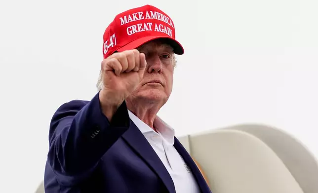 President Donald Trump gestures while boarding Air Force One at Morristown Airport, Sunday, Aug. 16, 2026, in Morristown, N.J. (AP Photo/Julia Demaree Nikhinson)