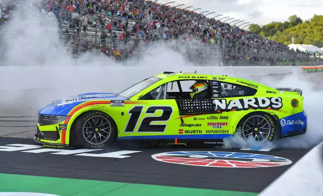 Ryan Blaney spins the wheels of his car after winning a NASCAR Cup Series auto race, Sunday, Aug. 23, 2026, in Loudon, N.H. (AP Photo/Steven Senne)