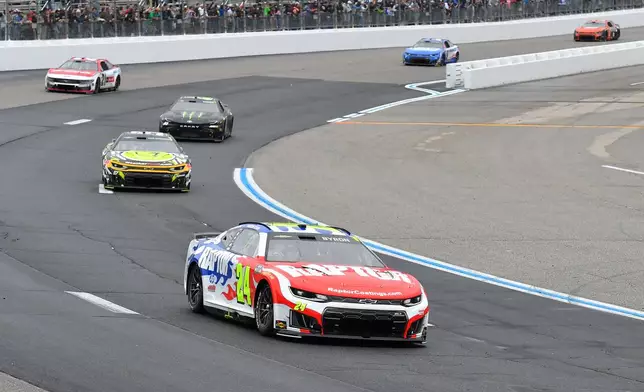 William Byron (24) leads through Turn 1 during a NASCAR Cup Series auto race, Sunday, Aug. 23, 2026, at New Hampshire Motor Speedway in Loudon, N.H. (AP Photo/Steven Senne)