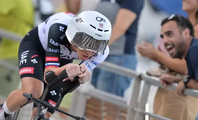 Slovenia's Tadej Pogacar rides to win the first stage of the La Vuelta cycling race, a time trial with start and finish in Monaco, Saturday, Aug. 22, 2026. (AP Photo/Philippe Magoni)