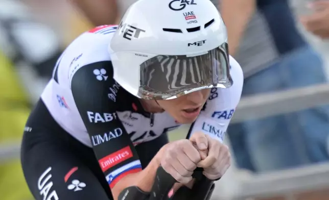 Slovenia's Tadej Pogacar rides to win the first stage of the La Vuelta cycling race, a time trial with start and finish in Monaco, Saturday, Aug. 22, 2026. (AP Photo/Philippe Magoni)