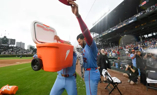 St. Louis Cardinals' Joshua Baez (22) gets dunked after defeating the Chicago Cubs in a baseball game against the Chicago Cubs in Chicago, Saturday, Aug. 15, 2026. (AP Photo/Paul Beaty)