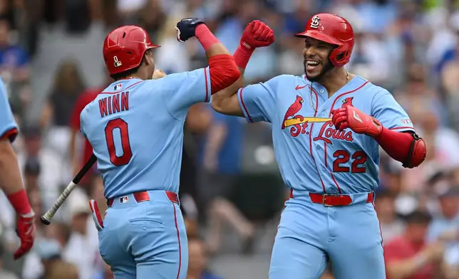 St. Louis Cardinals' Joshua Baez (22) celebrates with teammate Masyn Winn (0) after hitting a three-run home run during the first inning of a baseball game against the Chicago Cubs in Chicago, Saturday, Aug. 15, 2026. (AP Photo/Paul Beaty)