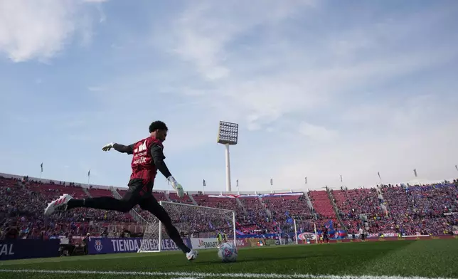 Colo Colo goalkeeper Vozinha, from Cape Verde, warms up for a Chilean soccer league match between Colo Colo and Universidad de Chile in Santiago, Chile, Sunday, Aug. 23, 2026. (AP Photo/Esteban Felix)