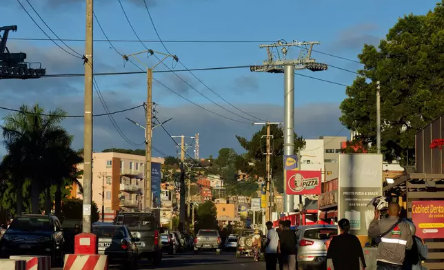Wires for cable cars cut across the skyline of Antananarivo, Madagascar, Friday, May 1, 2026. (AP Photo/Alexander Joe)