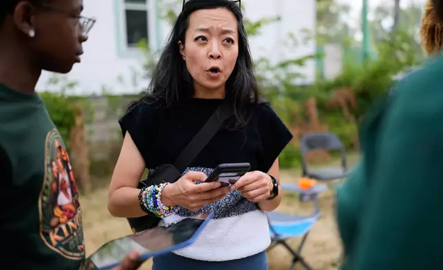 Democratic gubernatorial candidate Francesca Hong talks with Milwaukee residents during "We Outside" Annual Community Event at Metcalfe Park Rising, Friday, July 24, 2026, in Milwaukee. (AP Photo/Nam Y. Huh)