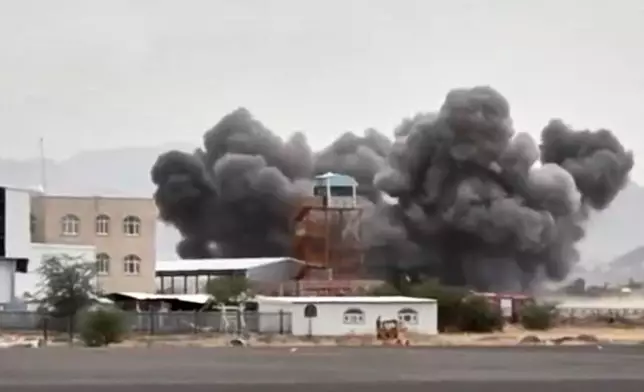FILE - This image taken from video broadcast by Al-Masirah TV, a Houthi-controlled news channel, shows an explosion at the Sanaa International Airport compound during what the Iranian-backed Houthi rebels in Yemen said were several Saudi airstrikes in Sanaa, Yemen, July 13, 2026. (Al-Masirah TV via AP, File)