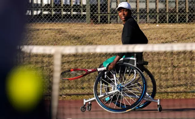 Kgothatso Montjane, a South African Paralympic wheelchair tennis champion, watches the ball after playing a return shot during practice in Pretoria, South Africa, Saturday, Aug. 1, 2026. (AP Photo/Themba Hadebe)