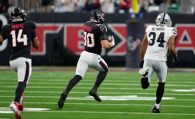 Houston Texans linebacker Wade Woodaz (30) returns an interception for a touchdown against the Las Vegas Raiders during the first half of an NFL preseason football game, Thursday, Aug. 20, 2026, in Houston. (AP Photo/David J. Phillip)