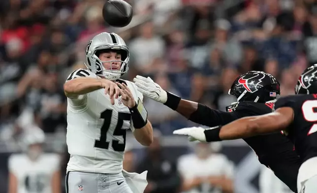 Las Vegas Raiders quarterback Fernando Mendoza (15) throws against the Houston Texans while under pressure during the first half of an NFL preseason football game, Thursday, Aug. 20, 2026, in Houston. (AP Photo/Ashley Landis)