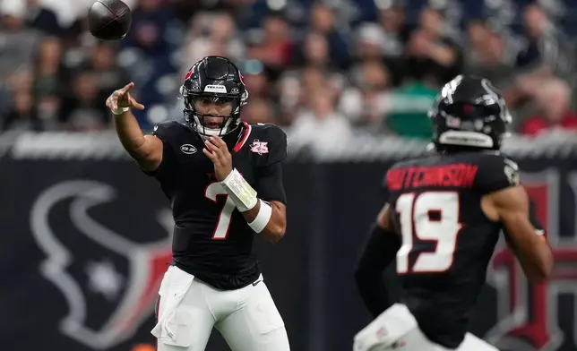 Houston Texans quarterback C.J. Stroud (7) throws to wide receiver Xavier Hutchinson (19) during the first half of an NFL preseason football game against the Las Vegas Raiders, Thursday, Aug. 20, 2026, in Houston. (AP Photo/Ashley Landis)