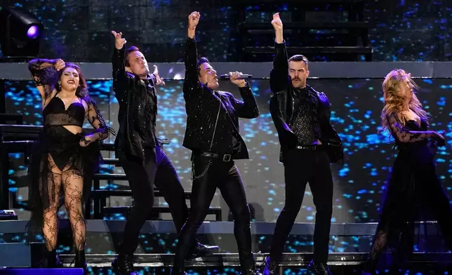 FILE - Puerto Rican pop singer Chayanne, center, performs in concert during his We Dance Again tour in Panama City on April 2, 2025. (AP Photo/Matias Delacroix, File)