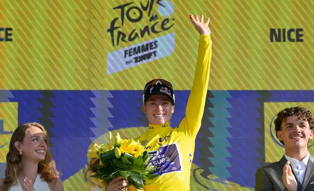 The overall leader Netherlands' Demi Vollering celebrates on the podium with the yellow jersey after the eighth stage of the Women's Tour de France cycling race (Tour de France Femmes) between Sisteron and Nice in Nice, France, Saturday, Aug. 8, 2026. (AP Photo/Philippe Magoni)