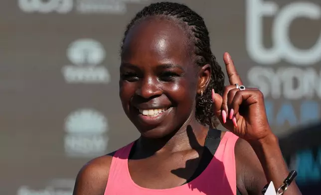 Peres Jepchirchir of Kenya reacts after crossing the finish line at the Opera House to win the women's Sydney Marathon, in Sydney, Sunday, Aug. 30, 2026. (AP Photo/Mark Baker)