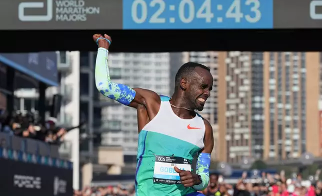 Addisu Gobena of Ethiopia reacts as he crosses the finish line at the Opera House to win the Sydney Marathon, in Sydney, Sunday, Aug. 30, 2026. (AP Photo/Mark Baker)