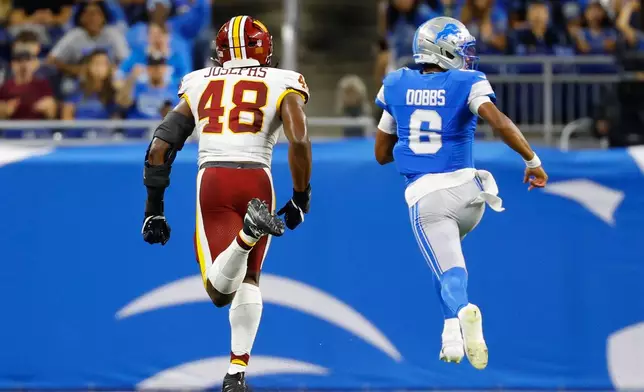 Detroit Lions quarterback Joshua Dobbs (6) runs in for a touchdown against Washington Commanders Joshua Josephs (48) during a preseason NFL football game, Saturday, Aug. 22, 2026, in Detroit. (AP Photo/Rey Del Rio)
