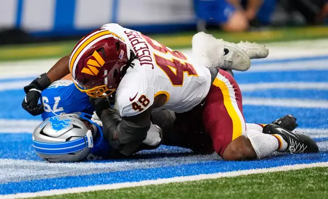 Washington Commanders Joshua Josephs (48) scores against Detroit Lions Foster Sarell during a preseason NFL football game, Saturday, Aug. 22, 2026, in Detroit. (AP Photo/Paul Sancya)