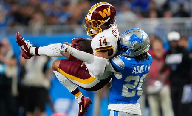 Washington Commanders wide receiver Antonio Williams (14) makes a catch against Detroit Lions cornerback Keith Abney II (28) during a preseason NFL football game, Saturday, Aug. 22, 2026, in Detroit. (AP Photo/Paul Sancya)