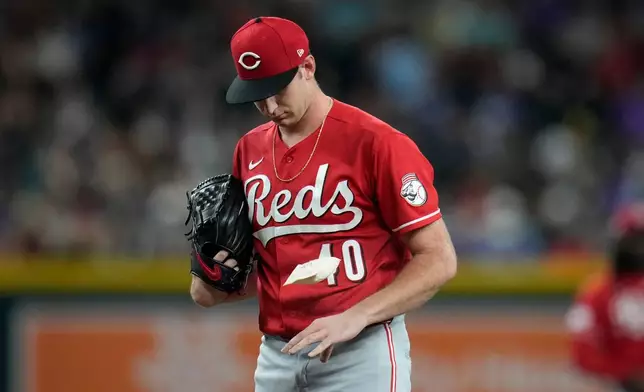 Cincinnati Reds starting pitcher Nick Lodolo flips the rosin bag during the first inning of a baseball game against the Arizona Diamondbacks, Friday, Aug. 21, 2026, in Phoenix. (AP Photo/Ross D. Franklin)