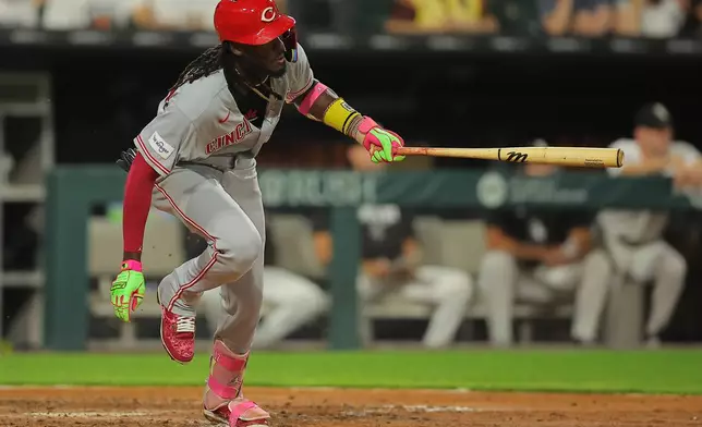 Cincinnati Reds' Elly De La Cruz hits an RBI single during the eighth inning of a baseball game against the Chicago White Sox, Tuesday, Aug. 11, 2026, in Chicago. (AP Photo/Melissa Tamez)