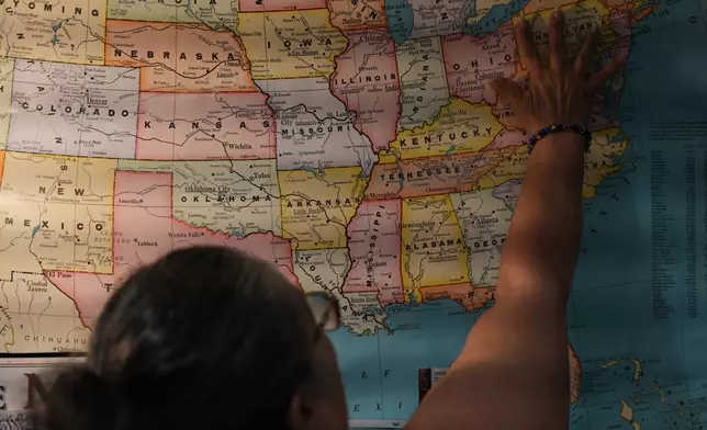 Leila Borrero Krouse, an immigration specialist with CATA, a nonprofit supporting farmworkers throughout the Eastern Shore, points to a U.S. map in her office to explain how many migrants come to the region to work as farmworkers, caregivers and in the poultry plants, in Salisbury, Md., Saturday, Aug. 1, 2026. (AP Photo/Luis Andres Henao)