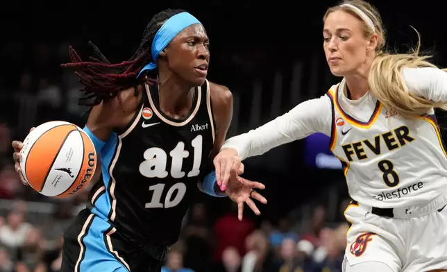 Atlanta Dream guard Rhyne Howard (10) dribbles against Indiana Fever guard Sophie Cunningham (8) in the first half of an WNBA basketball game Sunday, Aug. 16, 2026, in Atlanta. (AP Photo/Brynn Anderson)