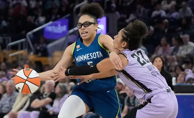 Minnesota Lynx guard Olivia Miles, left, drives to the basket against Golden State Valkyries guard Veronica Burton (22) during the first half of a WNBA basketball game in San Francisco, Wednesday, Aug. 19, 2026. (AP Photo/Jeff Chiu)