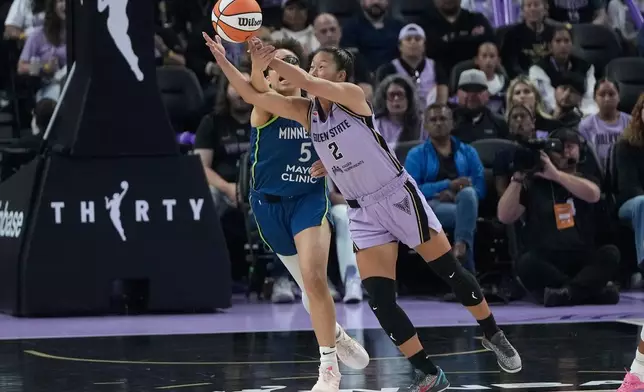 Golden State Valkyries guard Kaitlyn Chen (2) reaches for the ball against Minnesota Lynx guard Olivia Miles (5) during the first half of a WNBA basketball game in San Francisco, Wednesday, Aug. 19, 2026. (AP Photo/Jeff Chiu)