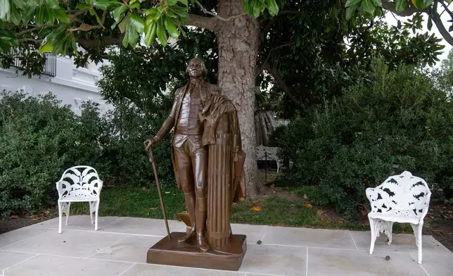FILE - A bronze statue of President George Washington is seen at the edge of the Rose Garden at the White House in Washington, Oct. 12, 2025. (AP Photo/Mark Schiefelbein, File)