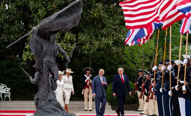 FILE - President Donald Trump walks on the red carpet in the Rose Garden with Britain's King Charles III, Queen Camilla and first lady Melania Trump at the White House, April 28, 2026, in Washington, during a State Visit. (AP Photo/Alex Brandon, File)